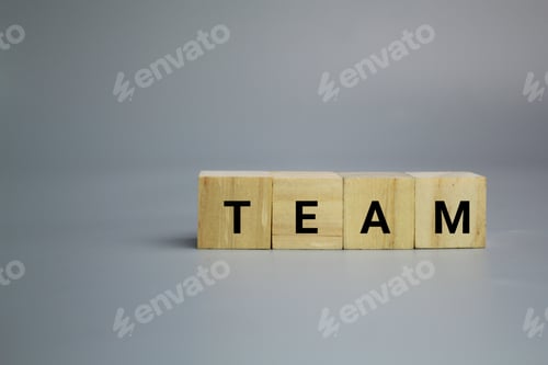 Preview: wooden cube with the word team.