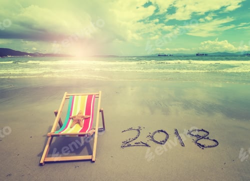Preview: Deck Chair With 2018 Written In Sand Write On Tropical Beach.