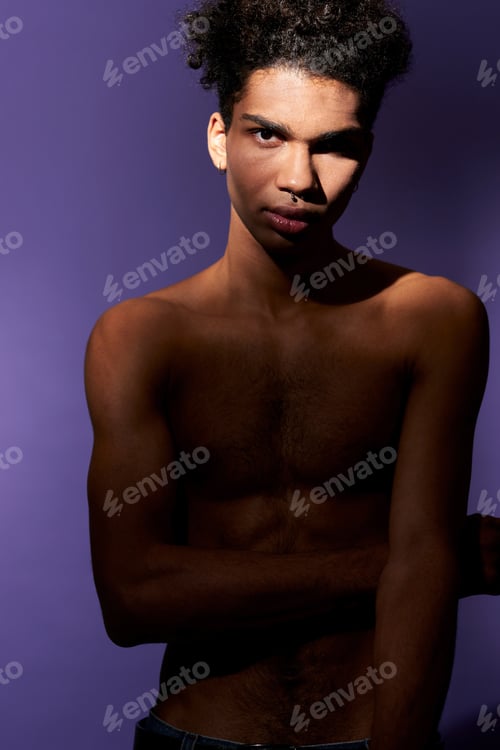 Preview: Portrait of young african american man standing in casual pose and looking camera. Transgender