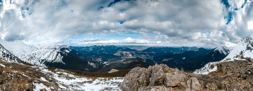 Snowy Mountain Range Landscape Panorama with Cloudy Sky