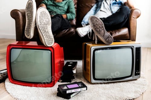 Preview: Two man sitting and two retro television
