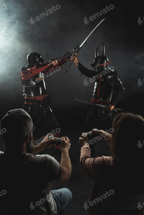 Preview: back view of man and woman playing samurai fighting in real life with gamepads on black