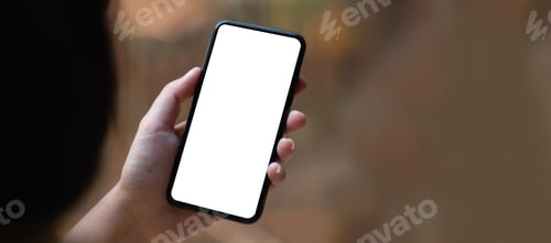 Preview: Top view Woman sitting on work desk and holding blank screen mock up mobile phone.