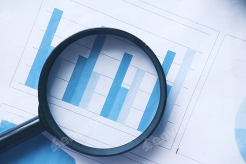 Preview: financial data and magnifying glass on blue .