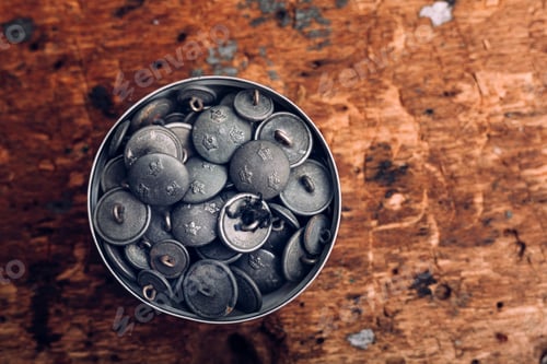 Preview: Directly above shot of jar filled with buttons on table at workshop
