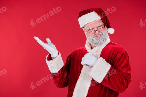 Preview: Santa Claus Holding Arm Up and Smiling on Red Background