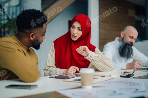 Preview: Muslim businesswoman leading a business meeting with her colleagues