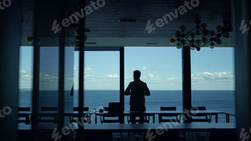 Preview: Business partner looking window rear view. Unknown businessman relax in hotel