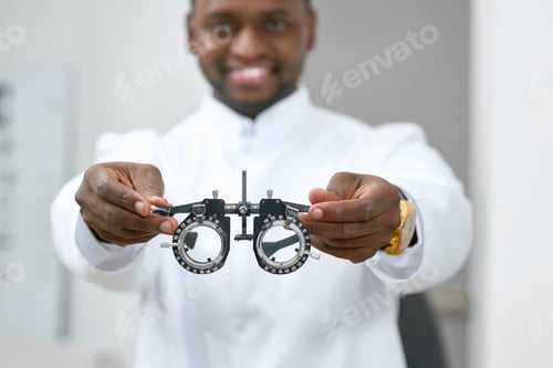 Preview: Smiling man giving medical lenses to try on