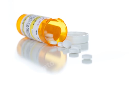 Preview: Non-Proprietary Medicine Prescription Bottle and Spilled Pills Isolated on White