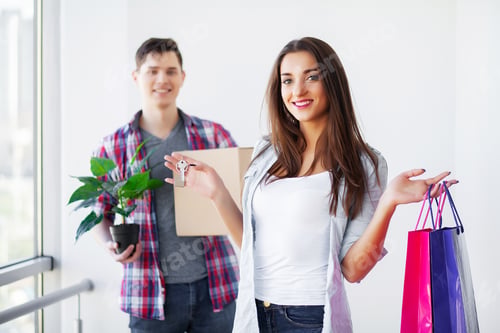Preview: Young happy couple moving into their new home. They unpacking and cleaning new home