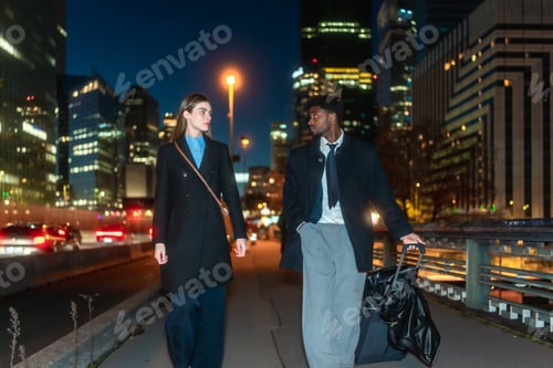 Preview: Professional man and woman walking city street at night