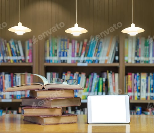 Preview: old book on the desk in library with tablet and Luxury lighting decoration