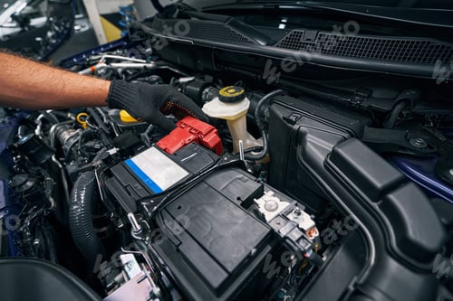 Preview: Person checking the car battery under bonnet
