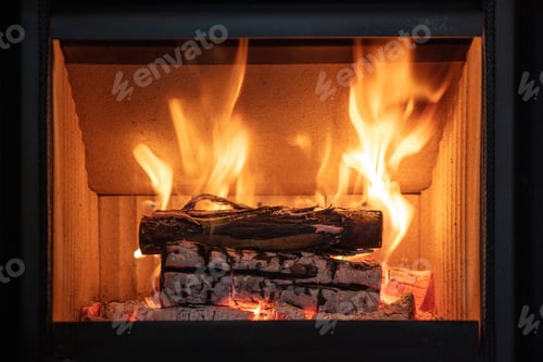 Preview: Fire flames and burning wood logs, energy stove fireplace close up,