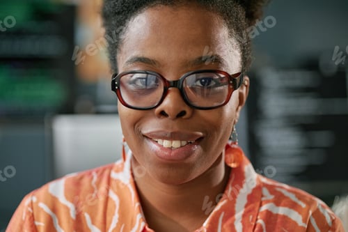 Preview: Portrait of Young Adult Black Woman Smiling and Looking into Camera