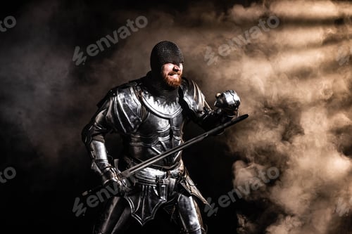Preview: handsome knight in armor holding sword and fighting on black background