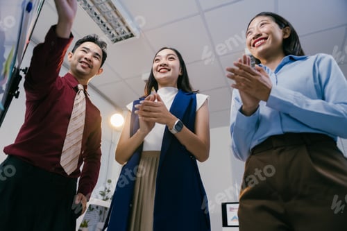 Preview: Diverse business team celebrates success in office meeting, showing teamwork and appreciation