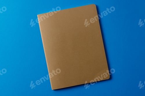 Preview: Close up of beige notebook with copy space on blue background