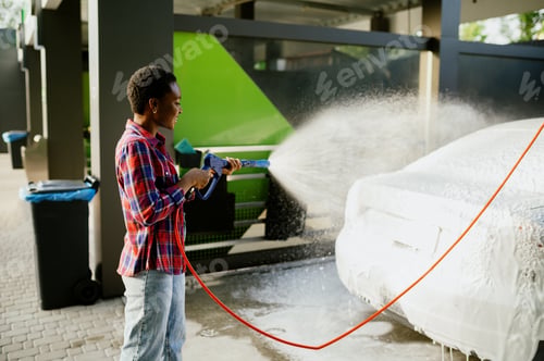 Preview: Woman using water gun with foam, hand car wash