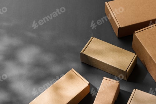 Preview: Various sizes of brown cardboard boxes arranged on a black surface with soft lighting effects during