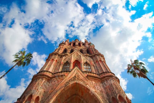 Preview: Looking up at Parroquia de San Miguel de Allende in Mexico. With palms on the sides.