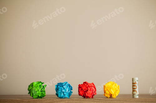 Preview: Great idea concept. Crumpled colorful paper on wooden table. Copy space