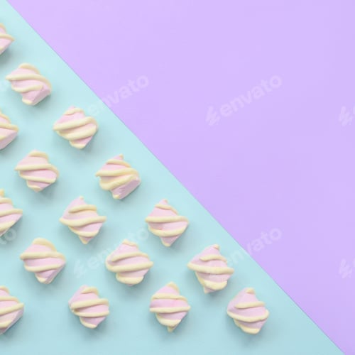 Preview: Colorful marshmallow laid out on violet and blue paper background