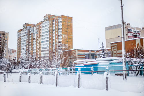 Preview: City landscape in winter. Snow-covered houses and streets of the city.