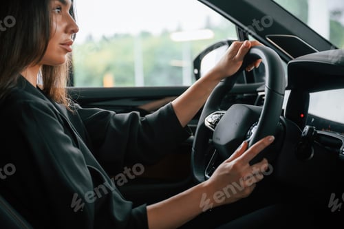 Preview: Enjoying the ride. Beautiful businesswoman is in the new car