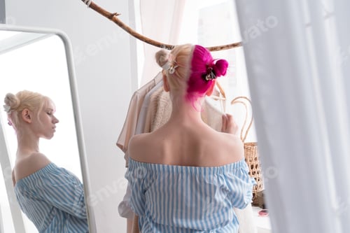 Preview: young woman in clothes store