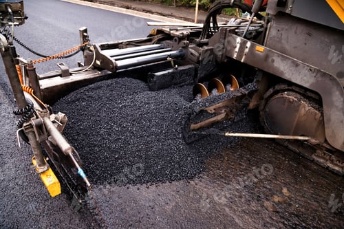 Preview: Asphalt Paver Machine Spreading Fresh Black Asphalt on a City Street