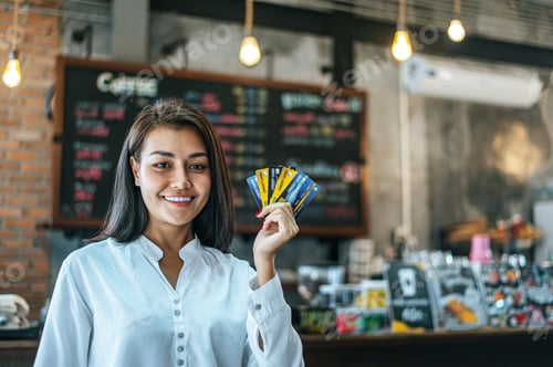 Preview: Young women enjoy shopping with credit cards.