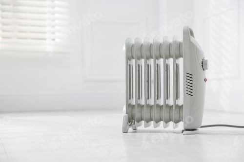 Preview: Modern electric heater at home, space for text