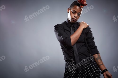 Preview: Portrait of young woman with hand on shoulder and serious expression