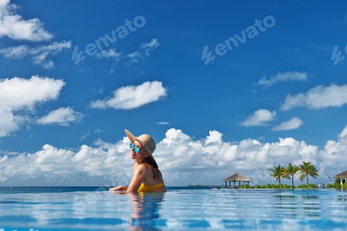 Preview: Woman In Hat Relaxing At The Pool
