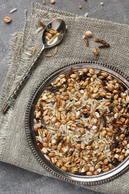 Preview: Uncooked multigrain rice in metal plate on wooden background