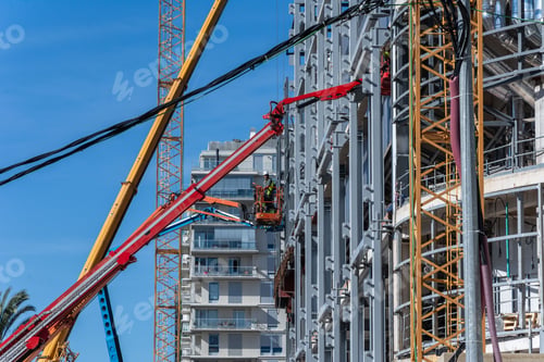 Preview: Construction site with cranes and steel framework against a blue sky