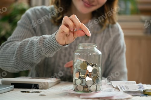 Preview: Woman Saving Money at Home in Jar