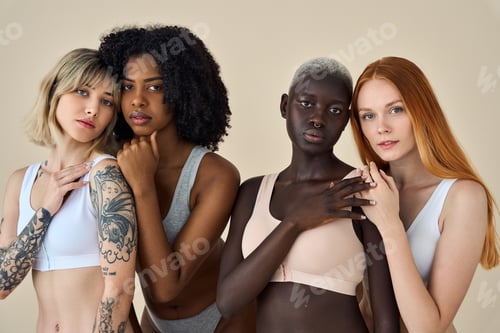 Preview: 4 diverse young girls in underwear bonding on beige background. Portrait.