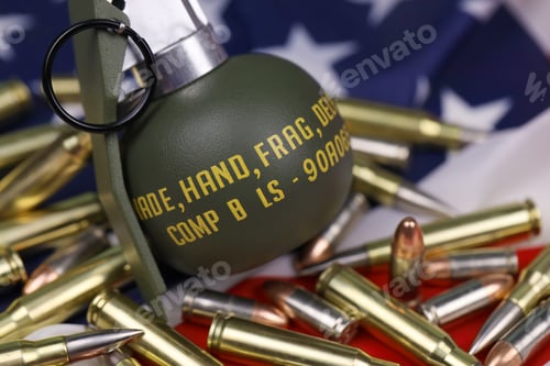 Preview: M67 frag grenade and many yellow bullets and cartridges on United States flag