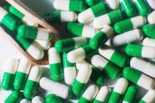 Preview: medicine green pills on white background on wooden spoon. sorted pharmaceutical