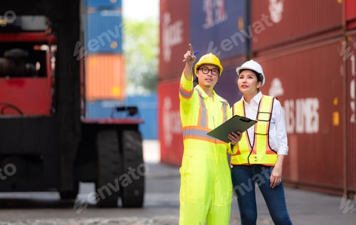 Preview: Portrait of Asian woman engineer and worker working with co-worker at overseas shipping container