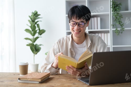 Preview: Young college student with glasses reding books in the study room.