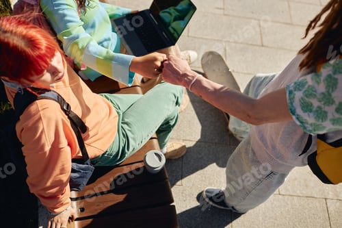 Preview: Teenage Boy Greeting Girl with Fist Bump on Park Bench