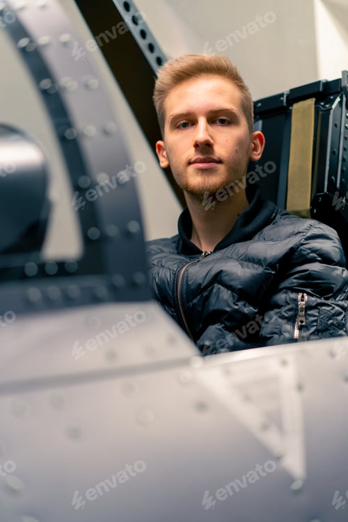 Preview: guy sits in flight simulator of a military plane before the start of a virtual flight entertainment
