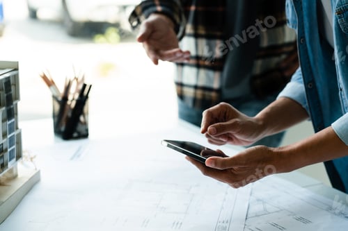 Preview: Architects Discussing Building Plans With Mobile Technology