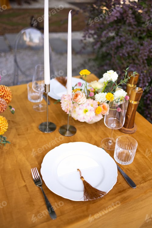 Preview: hairs and a table for guests, decorated with candles, are served with cutlery and crockery