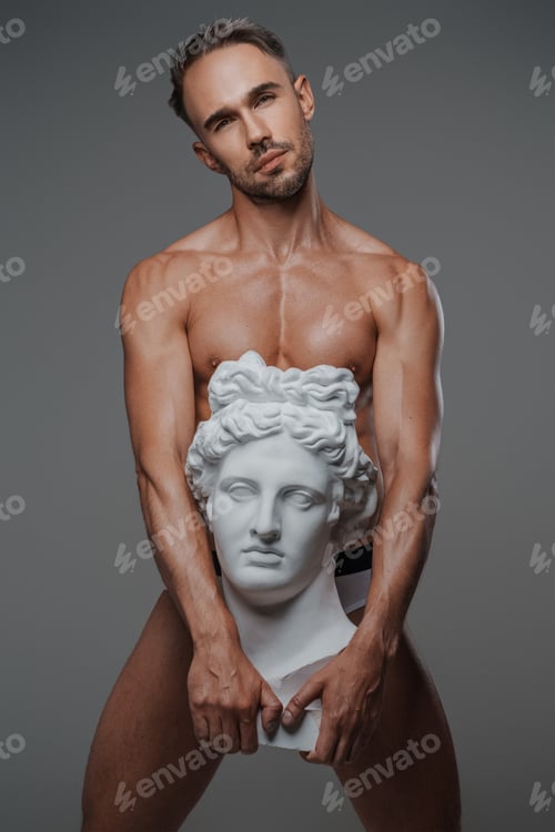 Preview: An attractive male model, dressed only in underwear on a gray backdrop