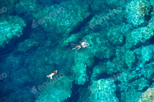 Preview: Drone view of a couple snorkeling in the sea